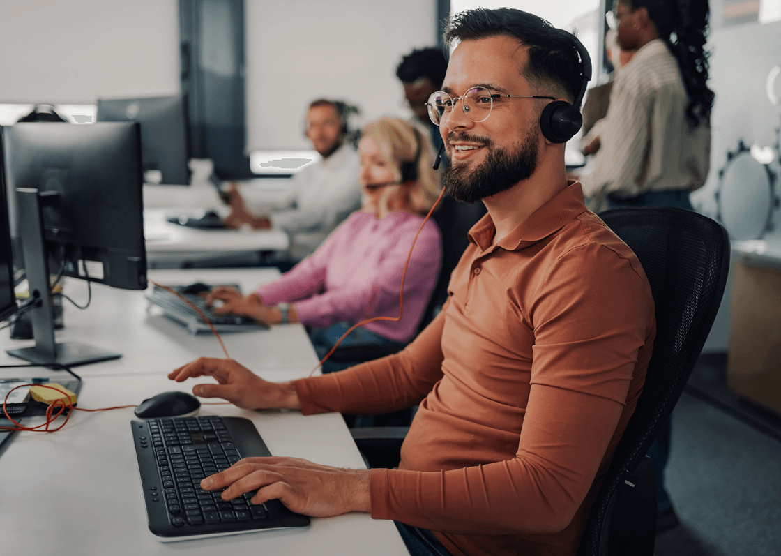 Man working at computer with headset