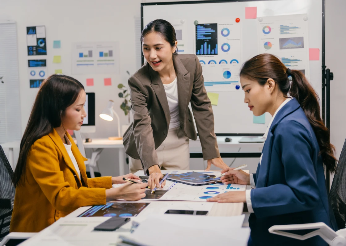 Team meeting with business charts