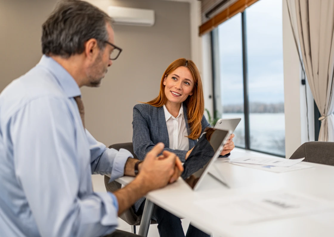 Colleagues discussing work at a table