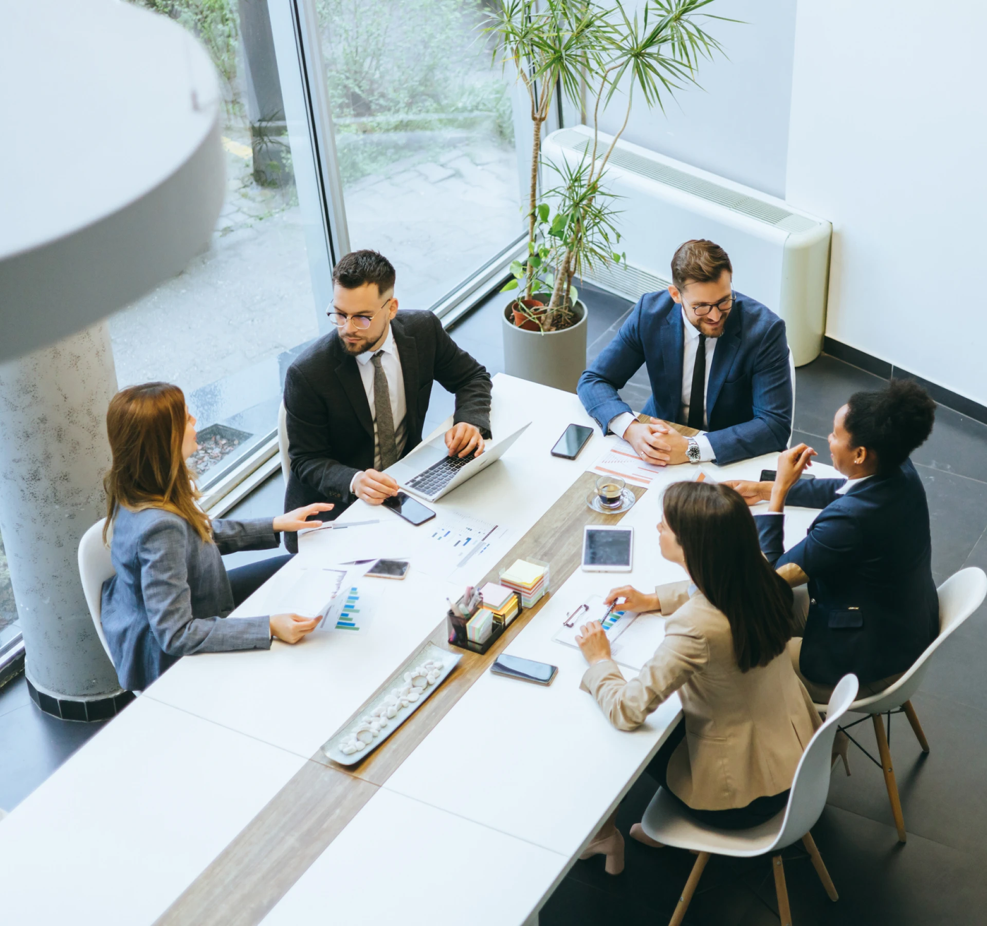 Business meeting with six professionals at table